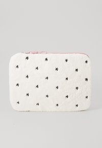 Fuzzy white zippered pouch with pink accent, featuring black embroidered bees and a textured surface. Rectangular shape, soft material.
