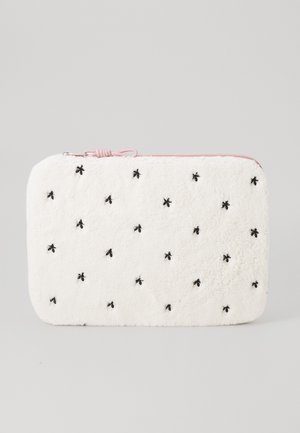 Fuzzy white zippered pouch with pink accent, featuring black embroidered bees and a textured surface. Rectangular shape, soft material.