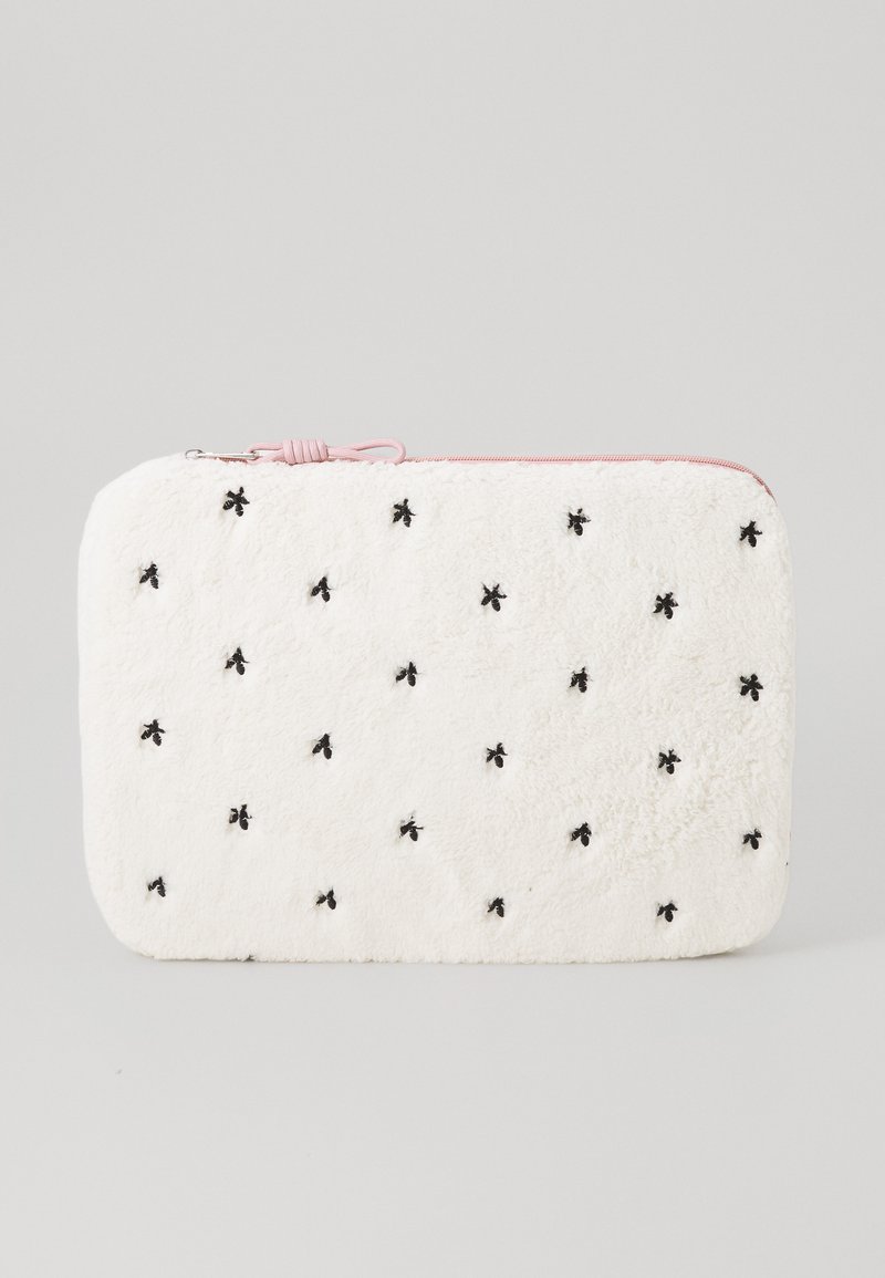 Fuzzy white zippered pouch with pink accent, featuring black embroidered bees and a textured surface. Rectangular shape, soft material.