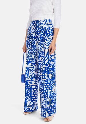 Blue and white wide-leg pants featuring abstract patterns, made of lightweight fabric. Paired with a textured white top and blue handbag.