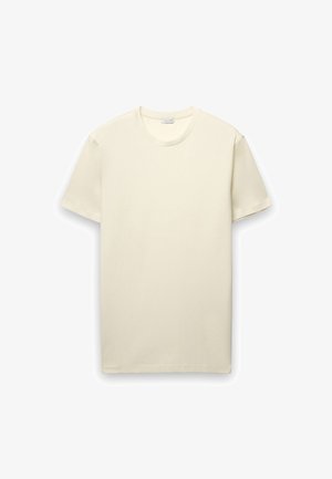 T-shirt a maniche corte color crema chiaro, realizzata in morbido cotone. Presenta una scollatura rotonda e un design semplice e classico senza motivi o dettagli.