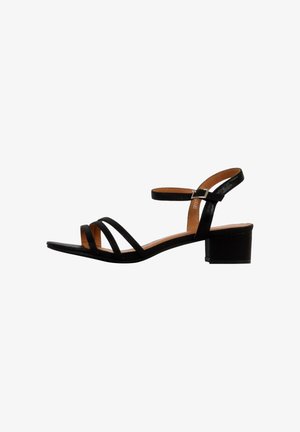 Black sandal with multiple skinny straps and a buckle closure. Features a low block heel and a smooth texture on the straps.