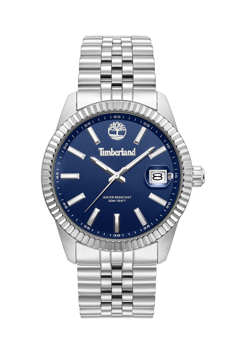 Orologio in acciaio inossidabile con quadrante blu, indicatori delle ore argentati e display della data. La lunetta è texturizzata, con un braccialetto in metallo intrecciato. Resistente all'acqua fino a 50 metri.