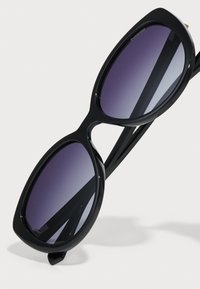 Ochelari de soare negri, ovali, cu lentile gradient violet, cadru din plastic neted și brațe subțiri, având un logo subtil pe lentilă.