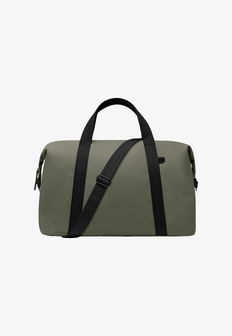 Zaļš ūdensizturīgs duffel somas ar melnu regulējamu plecu siksnu un izturīgām rokturēm. Gluda tekstūra, minimālistisks dizains, rāvējslēdzēja aizdare.