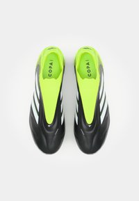 Black and neon yellow soccer cleats with a smooth finish, featuring three white stripes, slip-on design, and textured upper for grip.