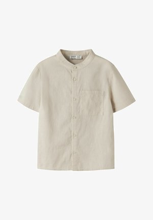 Cămașă cu mâneci scurte, de culoare bej, cu guler tip tunică, prevăzută cu nasturi în față și buzunar la piept. Confecționată dintr-un material ușor, cu o textură fină.