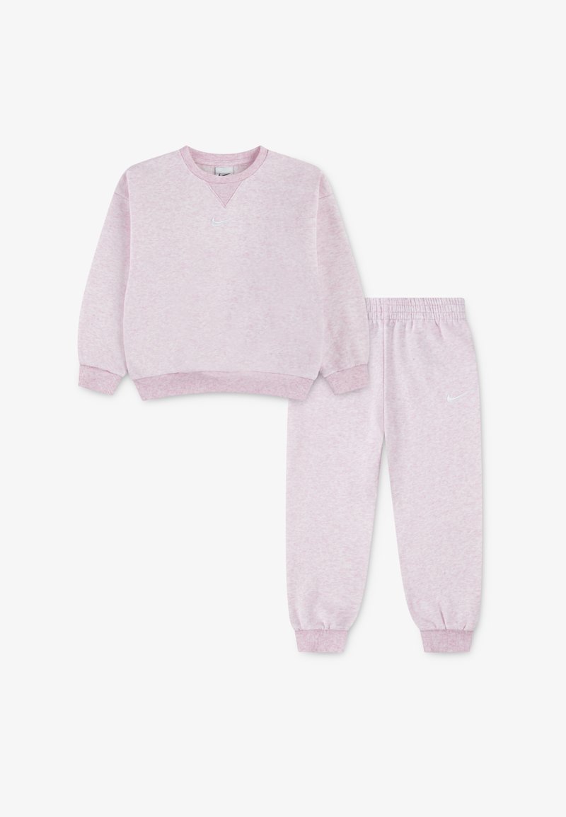 Pink, fleece sweatshirt with V-neck and ribbed cuffs, paired with matching joggers featuring elastic waistband and ankle cuffs. White logo accents.