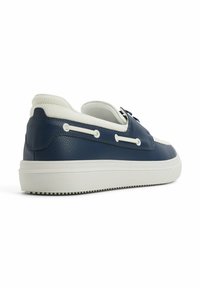 Marinblå lädersneaker med en strukturerad yta, krämfärgade accenter och en räfflad vit sula. Har dekorativ snörning på sidan.