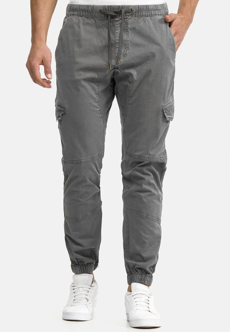 Gray cargo pants with elastic cuffs, drawstring waistband, and multiple pockets. Made from a soft, textured fabric with a relaxed fit.