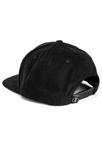 Black corduroy snapback cap with textured surface, curved visor, and adjustable strap. Features black hardware and logo tag at the back.