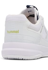 Baskets blanches avec une tige en maille texturée, semelle en caoutchouc et logo "hummel" vert lime. Comprend une languette à l'arrière.