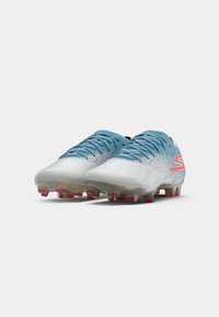 Light blue and silver soccer cleats with textured upper, laces, and colorful studs. Features a prominent logo in pink on the side.