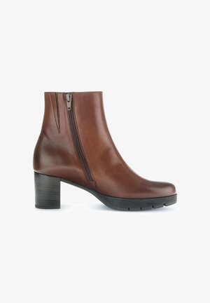 Braune Leder-Stiefelette mit Blockabsatz, seitlichem Reißverschluss, glatter Textur, runder Spitze und einer stabilen Gummisohle.