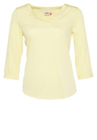 Haut jaune clair à manches longues avec un col en V et un ourlet arrondi. Fabriqué dans un tissu doux et lisse, avec un design simple et sans embellissement.