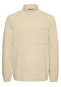 Beiger Rollkragenpullover aus weichem Strickstoff. Verfügt über eine Brusttasche sowie gerippte Bündchen und Saum. Einfaches, klassisches Design.