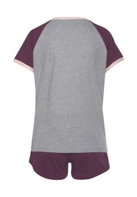 Gray jersey t-shirt with short, purple raglan sleeves and a pale pink neckline, paired with matching purple shorts. Simple design, soft texture.