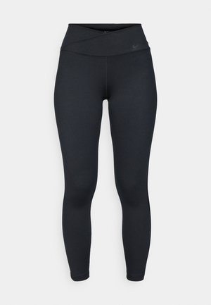Leggings noirs avec une taille haute croisée. Fabriqués dans un tissu lisse et extensible. Présentent une marque minimale près de la taille, coupe ajustée.