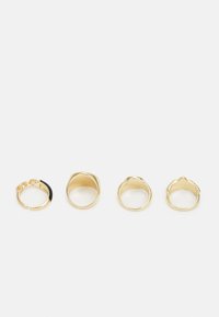 Conjunto de quatro anéis dourados com vários designs: um com corrente e detalhe preto, três lisos e arredondados, com texturas.