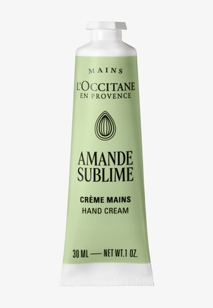 L'Occitane Amande Sublime handcrème tube, 30 ml, lichtgroen met zwarte tekst en witte dop, amandelpictogram onder merknaam.