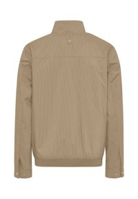Light brown jacket with a collared neck, long sleeves, and a smooth texture. Features button closures at the cuffs and subtle vertical lines.