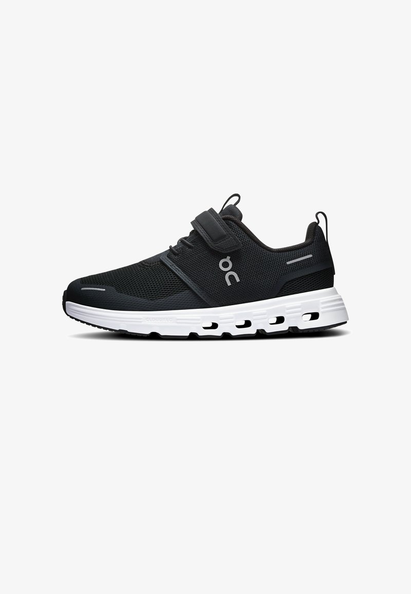 Chaussure de sport noire avec semelle blanche rembourrée, tige en mesh, sangle Velcro, languettes de traction et logo de la marque sur le côté.