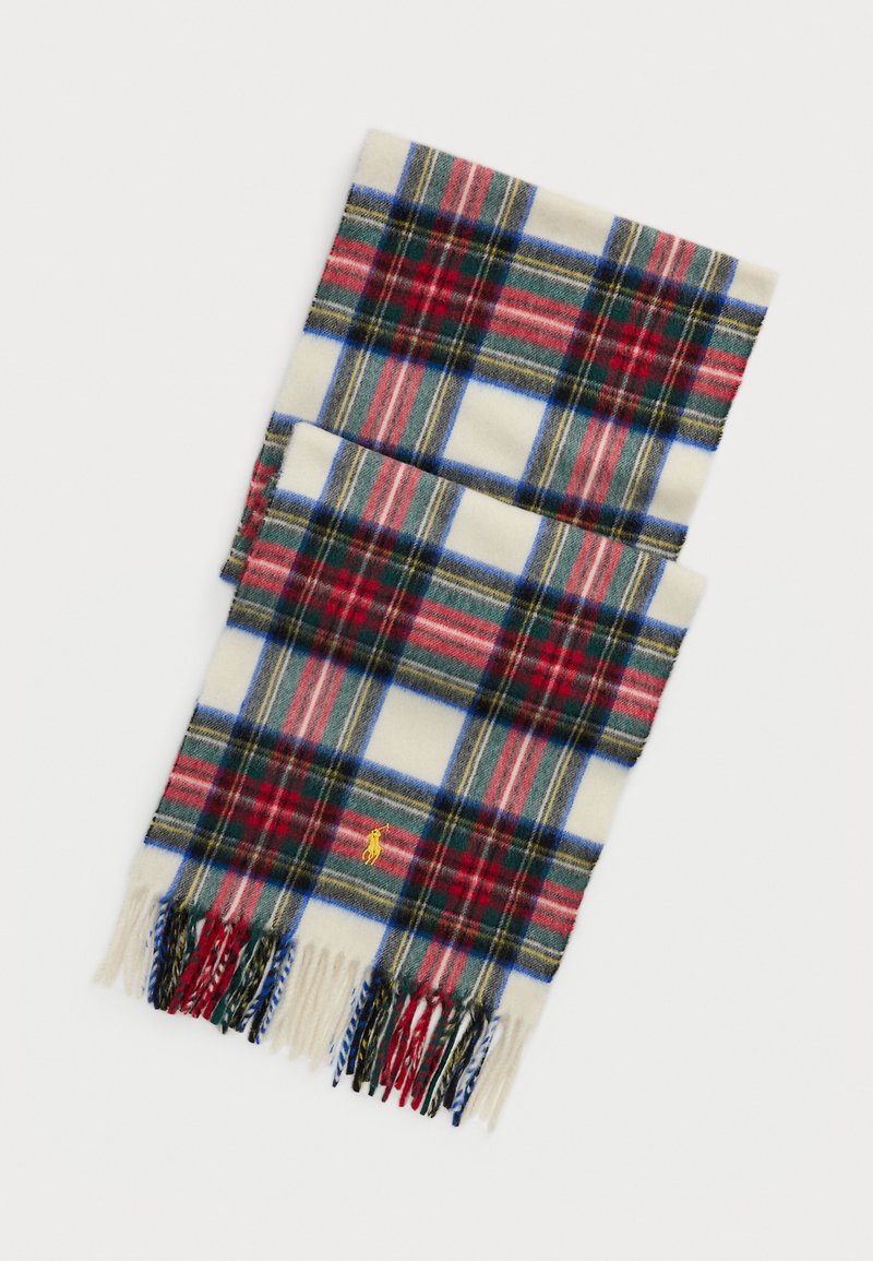 Plaid scarf in cream, red, blue, and green, made of soft fabric. Features fringed ends and a small yellow logo on the lower edge.