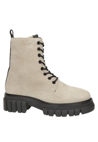 Botte montante en daim beige clair avec semelle en caoutchouc noire épaisse et languette à l'arrière, vue de profil.