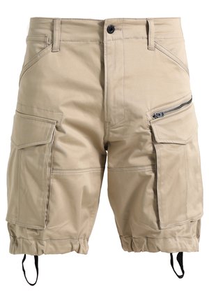 Beige cargoshorts gemaakt van een lichte stof. Heeft meerdere zakken, een ritszak aan de zijkant en verstelbare beenopeningen.