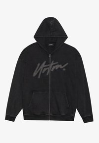 Black zip-up hoodie with a front pocket, featuring a large grey printed logo across the chest. Made of soft, textured fabric.