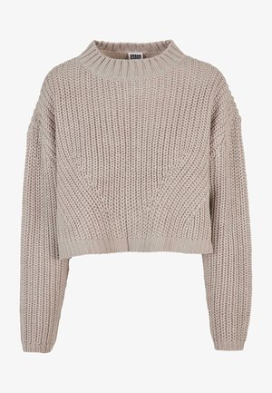 Hellbeige, verkürzter Pullover mit grober Stricktextur, hohem Kragen und überschnittenen Schultern. Mit gerippten Bündchen und Saum.