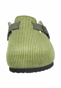 Green corduroy slip-on shoe with a textured upper, featuring a brown strap for adjustment and a black rubber sole.