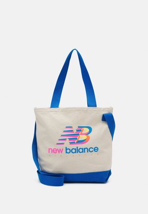 Canvas tote bag with blue handles and base, featuring a colorful New Balance Athletics logo in pink, blue, and orange on front.