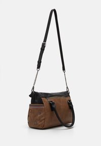 Torebka na ramię w jasnobrązowej skórze z czarnymi akcentami, z zamkiem błyskawicznym, regulowanym paskiem oraz kolorowymi, haftowanymi zdobieniami po bokach.