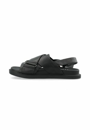 Black leather sandals with cross-strap design and buckle detail. Flat rubber sole and open heel. Smooth texture with a minimalist look.