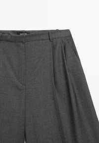 Grijze op maat gemaakte broek met een textuurstof, plooien aan de voorkant en een tailleband met een label. Klassiek design met een rechte pijp.