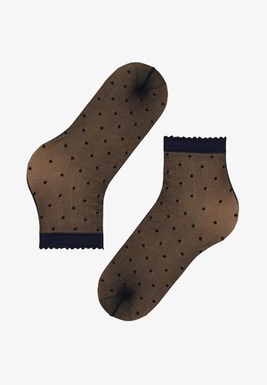 Paar doorschijnende zwarte enkelsokken met kleine zwarte stippen en gekartelde randen op een witte achtergrond.