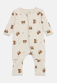 Beige bomullsdress med glidelås, med gjentatt bjørnemønster og poteavtrykk. Lange ermer med tettsittende mansjetter ved anklene.