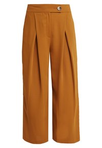 Hög midja vida byxor i bränd orange med frontveck, knäppning i midjan och utan synliga fickor.