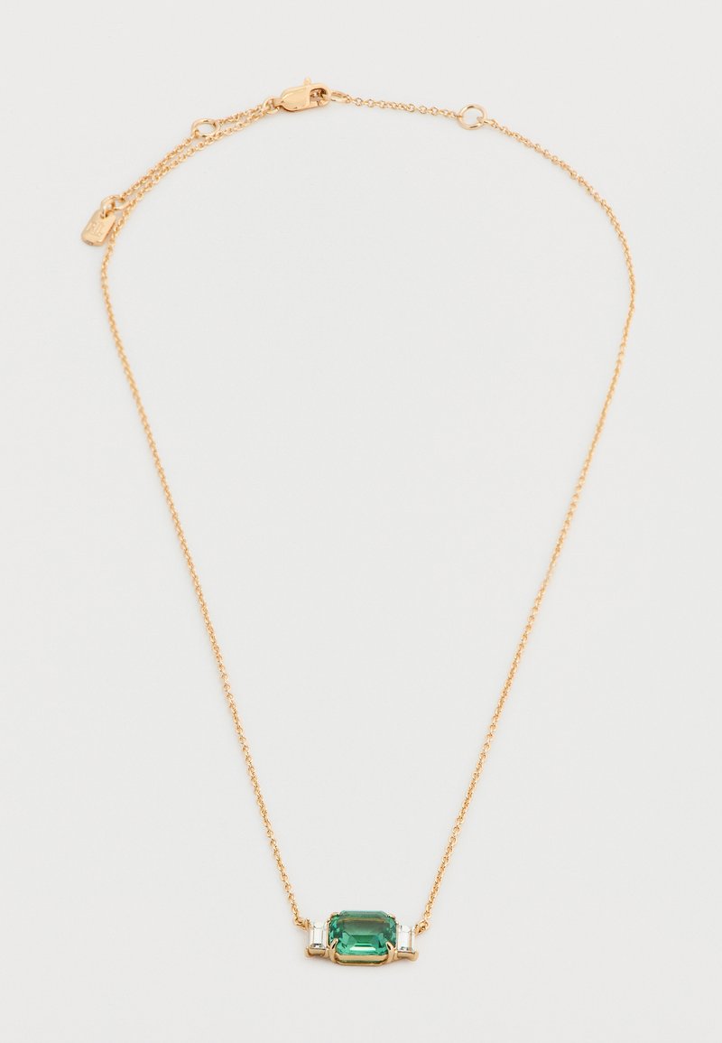 Λεπτό χρυσό κολιέ αλυσίδας με μια ορθογώνια πράσινη πολύτιμη πέτρα στο κέντρο, πλαισιωμένη από δύο μικρές διαυγείς πέτρες σε σχήμα μπαγκέτας.