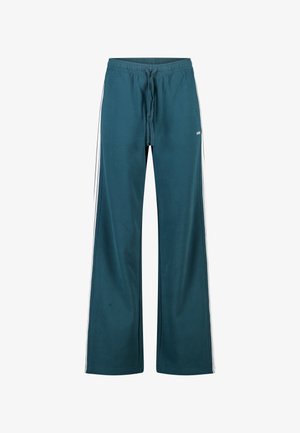 Pantalon de survêtement large couleur sarcelle en tissu doux, avec une taille à cordon de serrage et des bandes blanches sur le côté. Reconnu pour sa coupe décontractée.