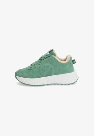 Green suede sneakers with a fuzzy beige lining, round logo detail, and white textured sole. Features a lace-up design and pull tab.