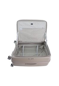 Light beige hard-shell suitcase with dual wheels, open zipper, and gray fabric interior featuring compartments and logo tag.