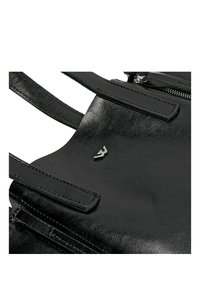 Černá kabelka z umělé kůže s dvojitými uchy, obsahující zipovou kapsu a malý kovový logo akcent na přední straně. Hladký povrch.