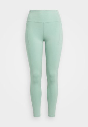 Leggings vert menthe taille haute, longueur intégrale, avec poches latérales cousues et finition lisse, présentés sur fond blanc.