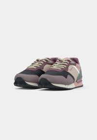 Sneakers featuring a mix of purple, green, and beige textiles, round toe, cushioned sole, and contrasting laces. Textured accents present.