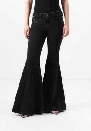 Black flared jeans made of denim, featuring a high waist, front pockets, and a smooth texture. Decorative stitching on the pocket edges.