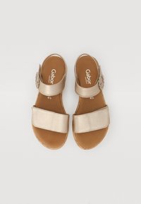 Gabor sandals in metallic gold with two wide straps, an adjustable buckle, and a cork sole for comfort. Flat design with a casual appearance.