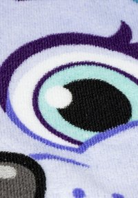 Plush fabric in light purple features a stylized eye design with black, teal, and white accents. Textured, colorful patterns are visible.