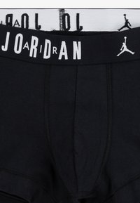 Black cotton boxer briefs with a white elastic waistband featuring "JORDAN" and logo accents. Smooth texture, reinforced stitching details.